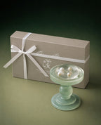 Luxury handmade soap gift set featuring a transparent hydrating soap with four freshwater pearls, displayed on a handcrafted glass soap dish beside a premium gift box.